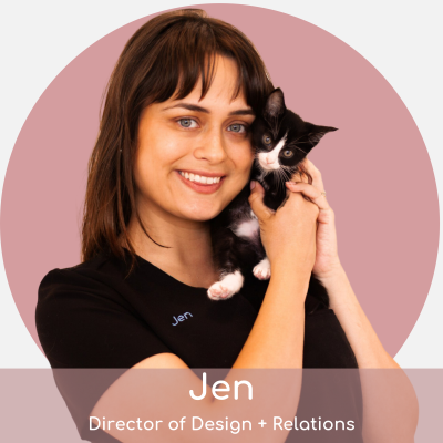 ja A woman named jen, smiling and holding a small black and white kitten, against a soft pink background. she is identified as a marketing director.
